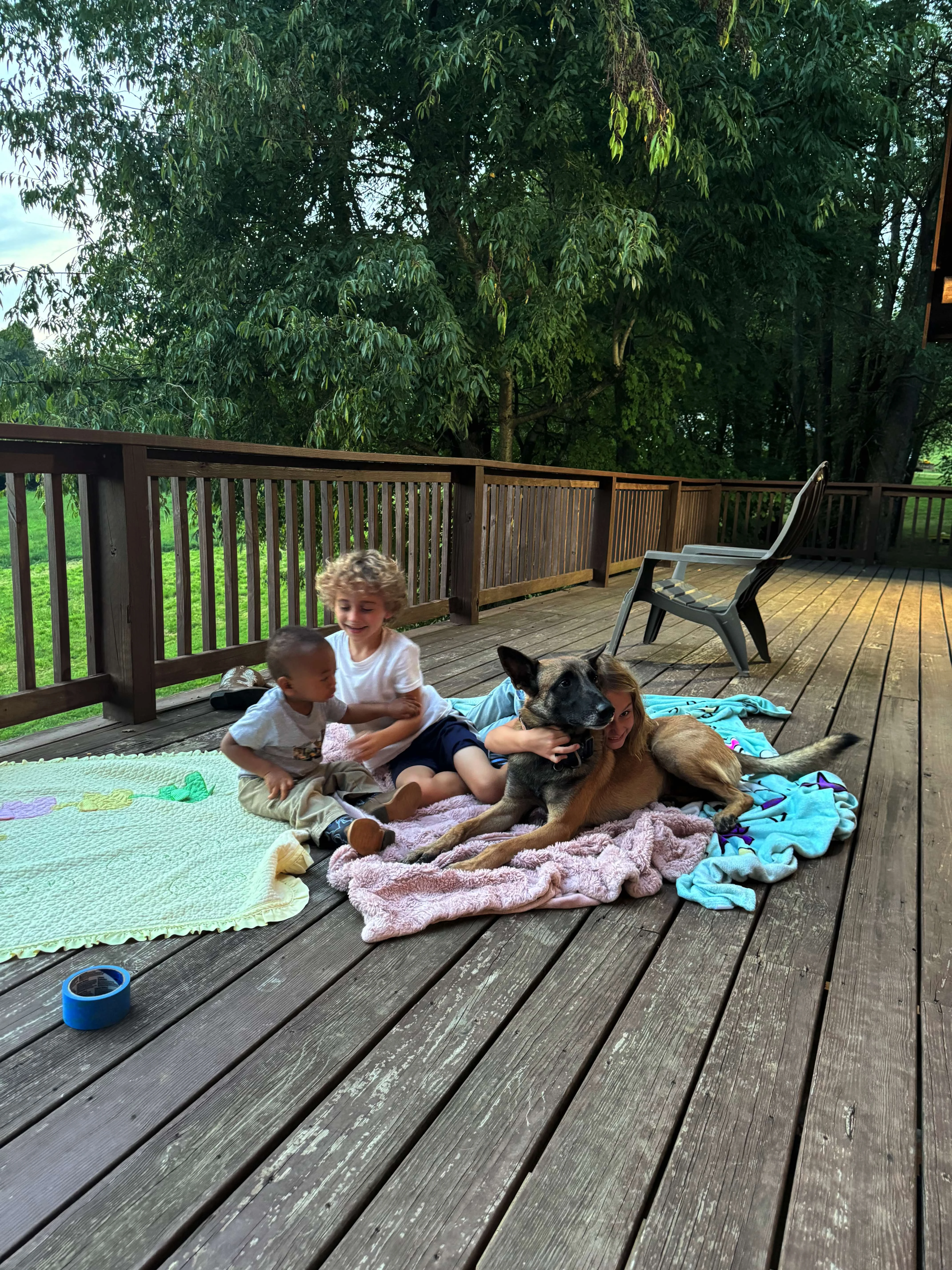Belgian Malinois with children on deck